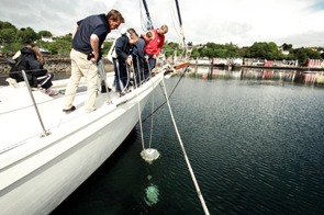 Students using a plankton net to discover microscopic marine creatures